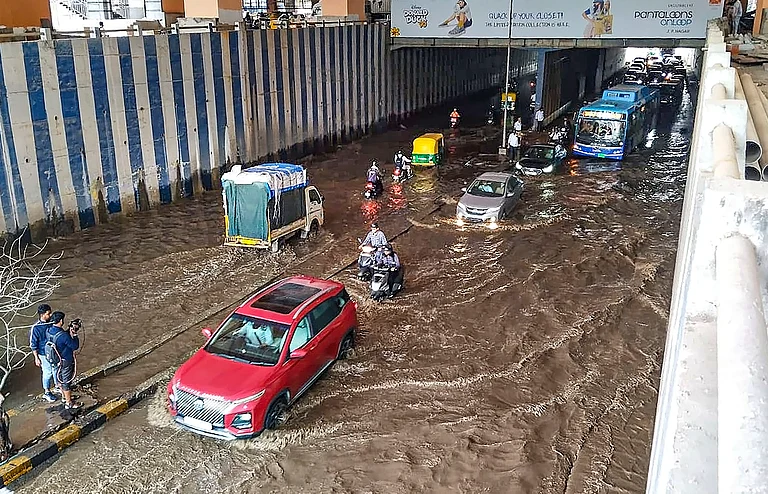 Vehicles pass through a waterlogged underpass near Jayadeva Hospital after heavy rainfall, in Bengaluru, Monday, Aug 12 - PTI